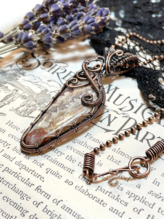 Crazy Lace Agate Pendant woven in Copper